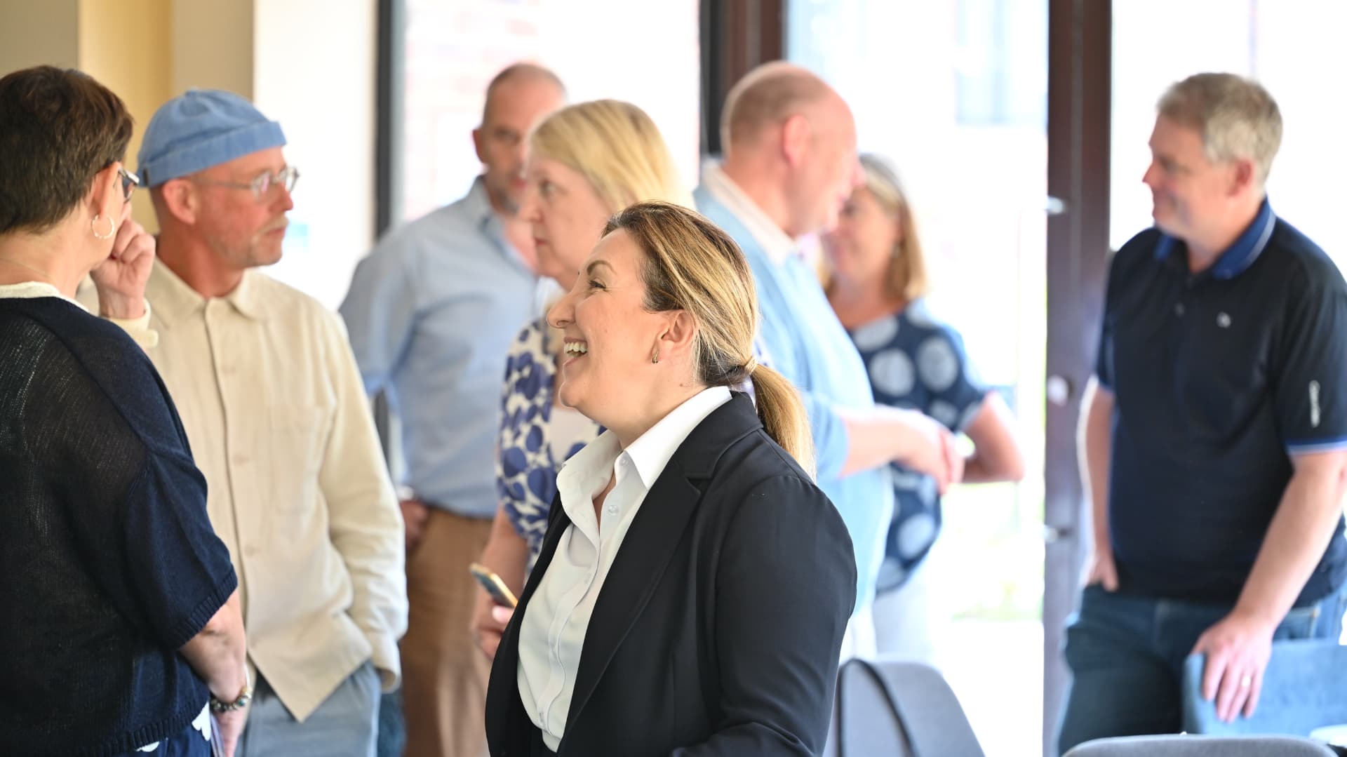 People talking and laughing together at a Hampshire business networking event